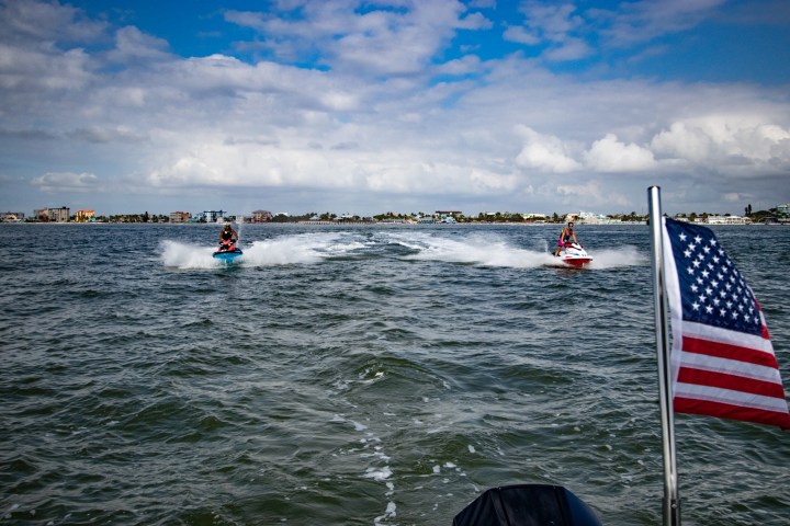 a group of people on a boat in a body of water